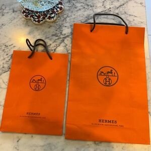 Classic Orange Hermes’ paper shoppers. 2 available.